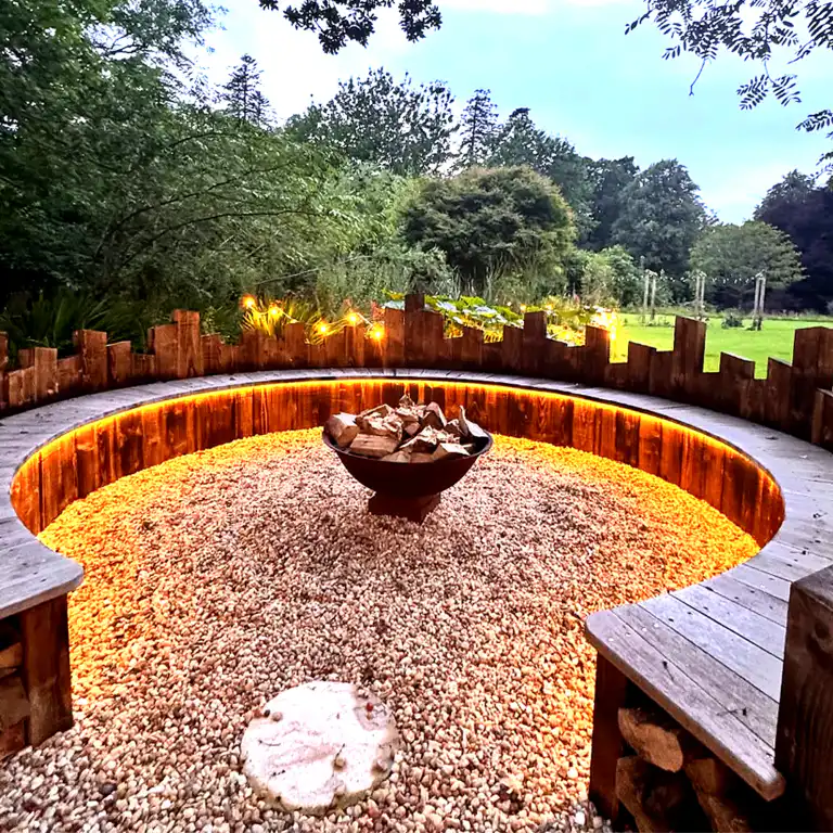 Illuminated outdoor ceremonial fire circle at Ladyburn House Scotland, built for evening gatherings on our Yoga, Meditation and Healing retreat.